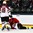 GRAND FORKS, NORTH DAKOTA - APRIL 17: Latvia's Emils Gegeris #20 on the ice after a hit from USA's Zachary Walker #15 resulting in a penalty against USA while Latvia's Sandis Smons #19 looks on during preliminary round action at the 2016 IIHF Ice Hockey U18 World Championship. (Photo by Matt Zambonin/HHOF-IIHF Images)

